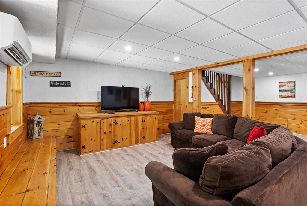 4 Fox Lane Westborough, MA 01581 - Photo 30 of 37 a living room with furniture and a flat screen tv