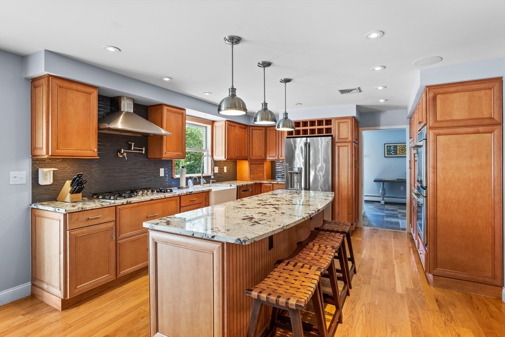 4 Fox Lane Westborough, MA 01581 - Photo 3 of 37 a kitchen with stainless steel appliances granite countertop a refrigerator a sink dishwasher a stove and white cabinets with wooden floor