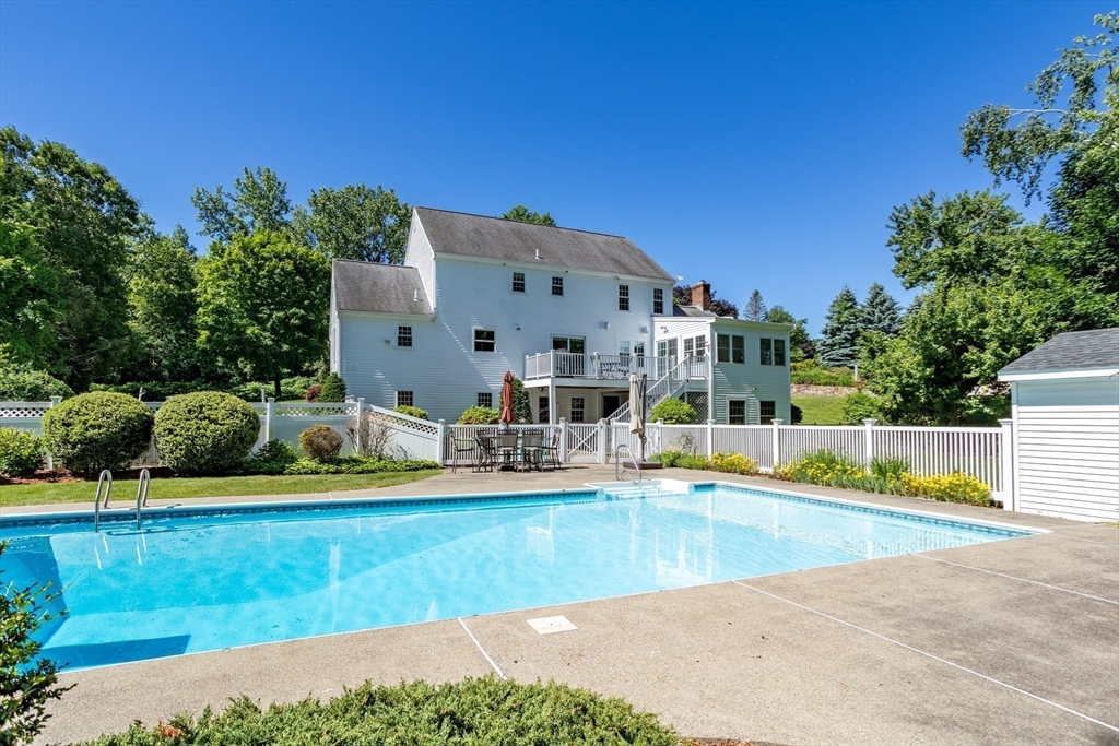 4 Fox Lane Westborough, MA 01581 - Photo 35 of 37 a view of swimming pool with outdoor seating and trees in the background