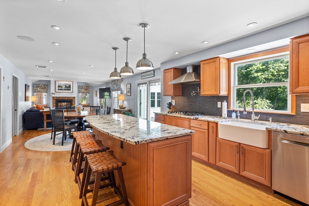 4 Fox Lane Westborough, MA 01581 - Photo 5 of 37 a kitchen with stainless steel appliances granite countertop sink stove and wooden cabinets