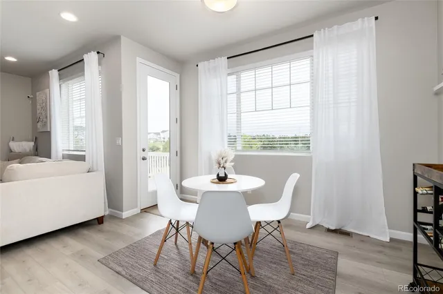 a dining room with wooden floor and a table