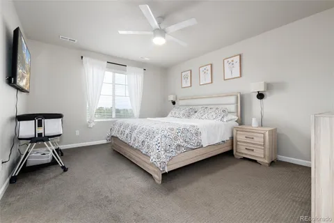 a bedroom with a bed and a chair