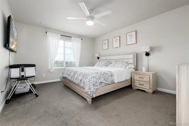 a bedroom with a bed and a chair