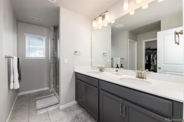 a bathroom with a double vanity sink a and mirror
