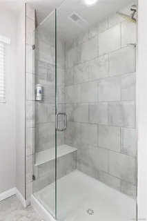 a bathroom with a shower and a sink
