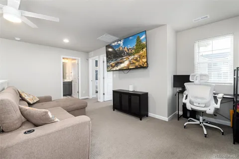 a bedroom with furniture and a flat screen tv