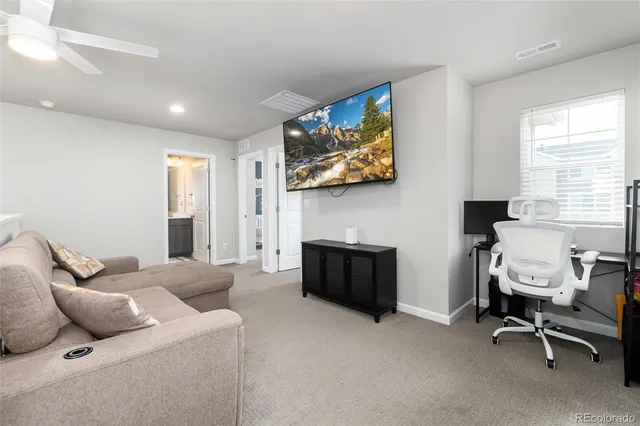 a bedroom with furniture and a flat screen tv