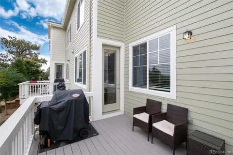 a balcony view with a couch and table and chairs