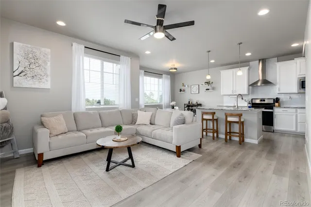 a living room with furniture and kitchen view
