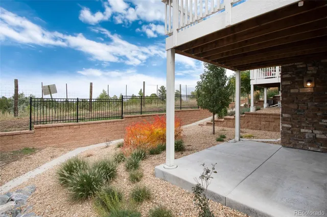 a view of a backyard with wooden fence