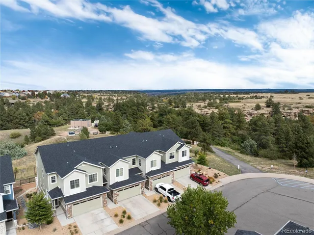 an aerial view of residential houses with outdoor space