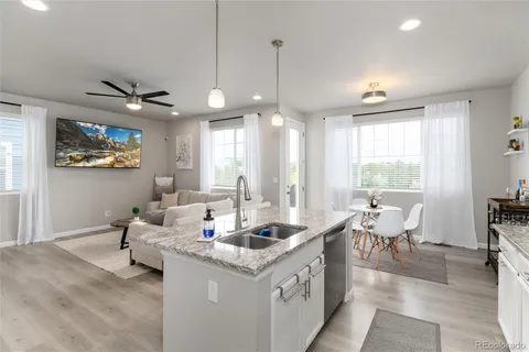 a living room with granite countertop furniture and a chandelier