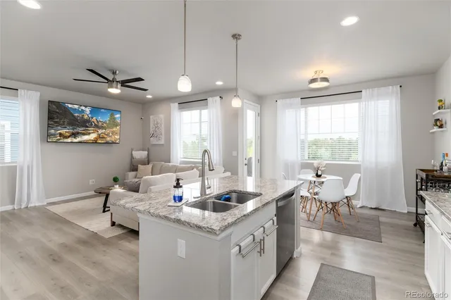 a living room with granite countertop furniture and a chandelier