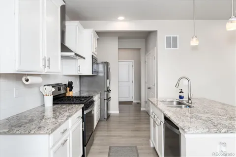a kitchen with granite countertop a sink and cabinets
