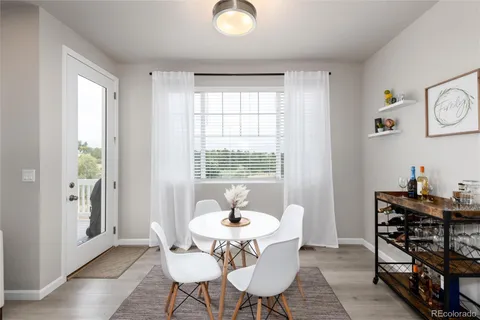 a dining room with furniture and window