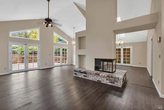 a living room with fireplace furniture and a floor to ceiling window