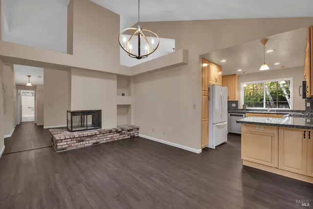 a kitchen with refrigerator and cabinets