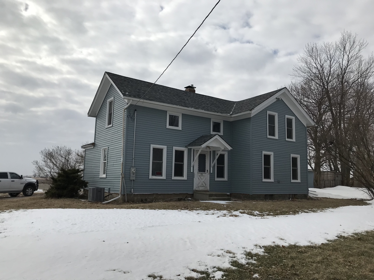 1994 Houghtby Road Shabbona, IL 60550 - Photo 1 of 45 a front view of a house with a yard covered in snow