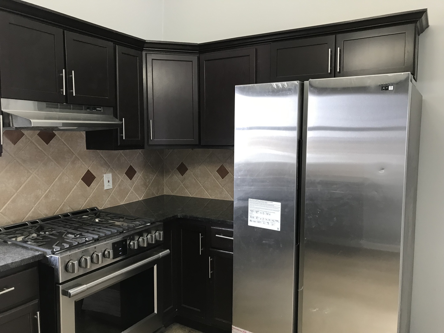 1994 Houghtby Road Shabbona, IL 60550 - Photo 5 of 45 a kitchen with a refrigerator and a stove top oven