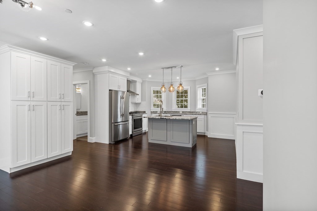 32 Jackson Road, Unit A Somerville, MA 02145 - Photo 5 of 21 a large white kitchen with lots of counter space wooden floor and appliances