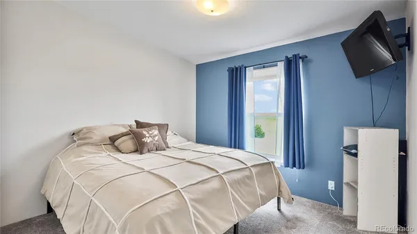 a bedroom with a bed and a television