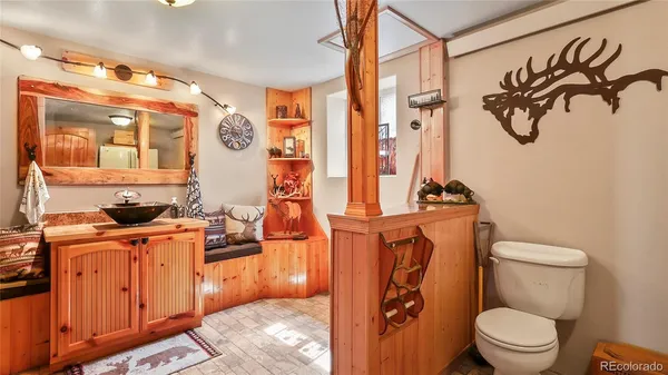 a bathroom with a toilet sink and mirror
