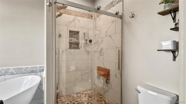 a bathroom with a shower a toilet and sink