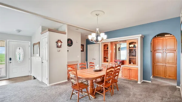 a view of a dining room with furniture and chandelier