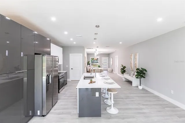 a kitchen with stainless steel appliances a refrigerator stove and microwave