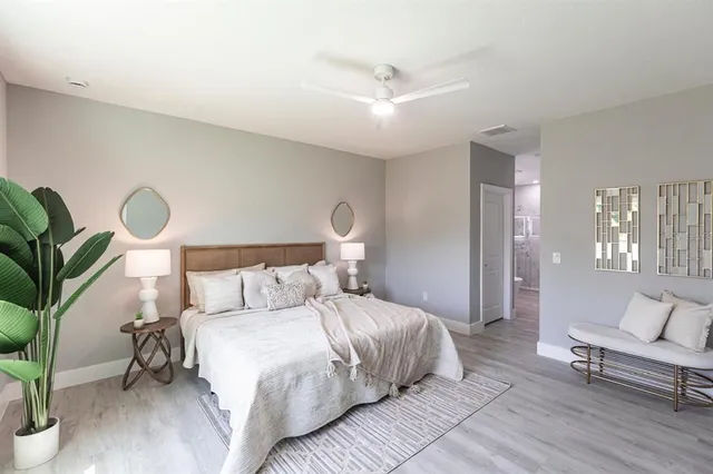 a bedroom with a large bed and a window