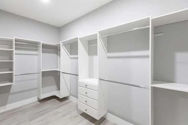 a view of walk in closet with white walls
