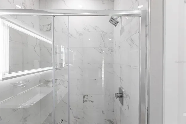 a bathroom with a bathtub a sink and mirror