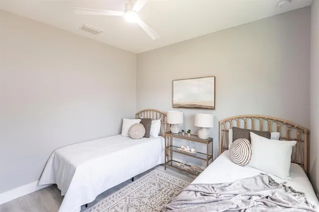 a bedroom with a large bed couch and a window