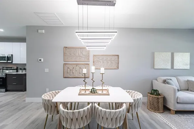 a view of a dining room with furniture window and wooden floor