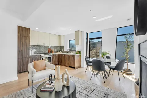a living room with furniture kitchen and a table