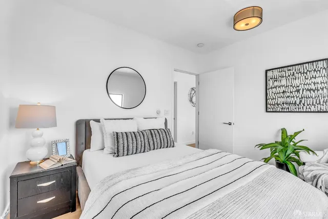 a bedroom with a bed and a lamp