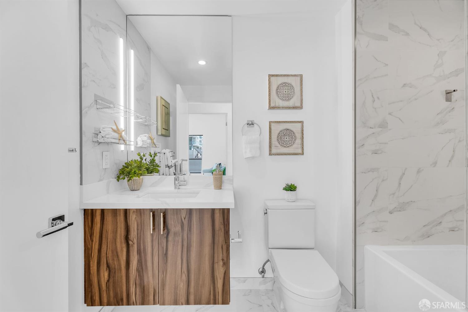 236 Shipley, Unit 405 San Francisco, CA 94107 - Photo 16 of 35 a bathroom with a granite countertop sink a toilet and shower