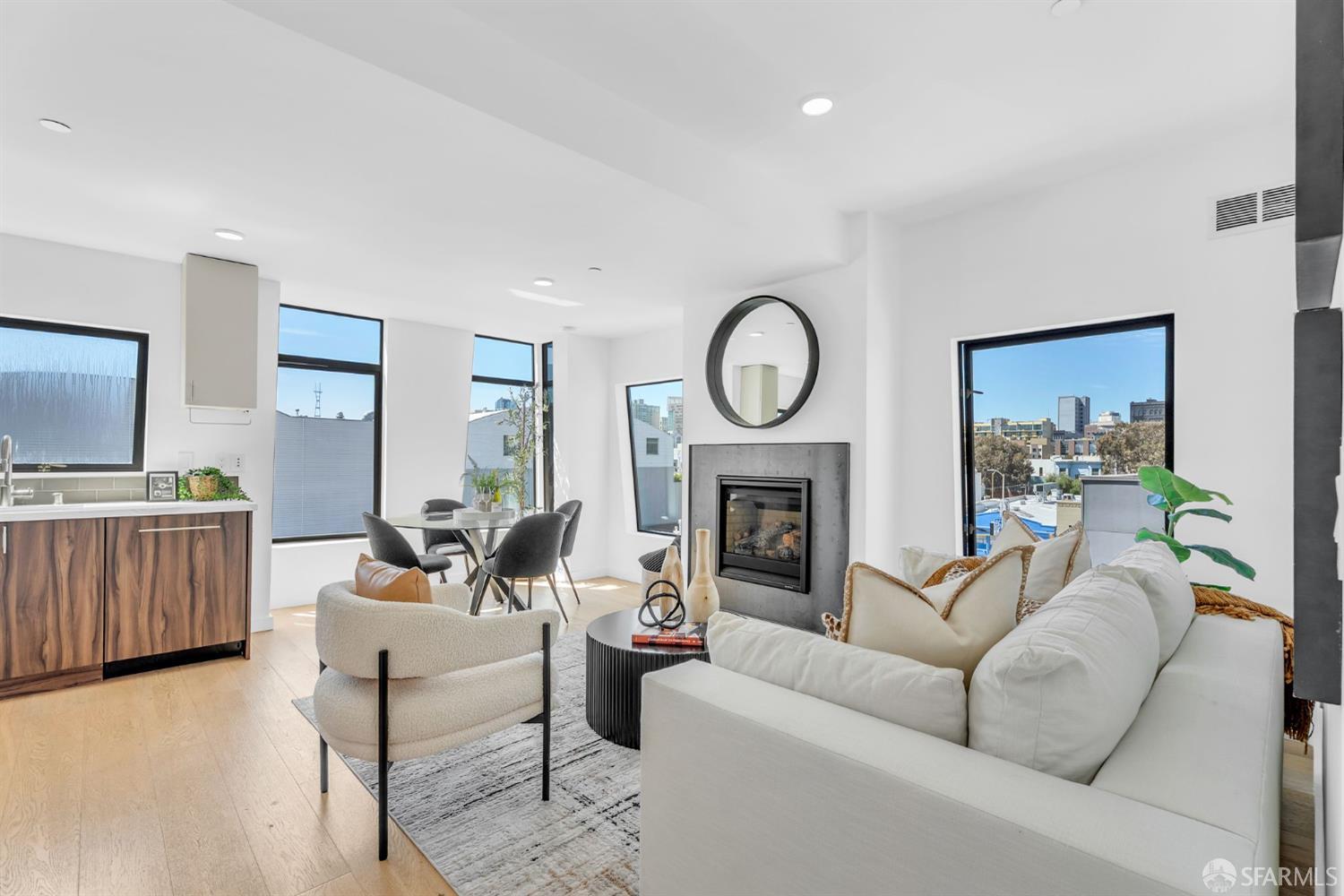 236 Shipley, Unit 405 San Francisco, CA 94107 - Photo 3 of 35 a living room with furniture a fireplace and a flat screen tv