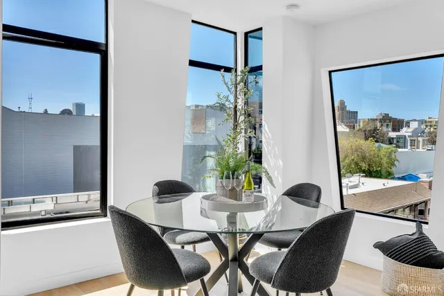 a view of a dining room with furniture and wooden floor