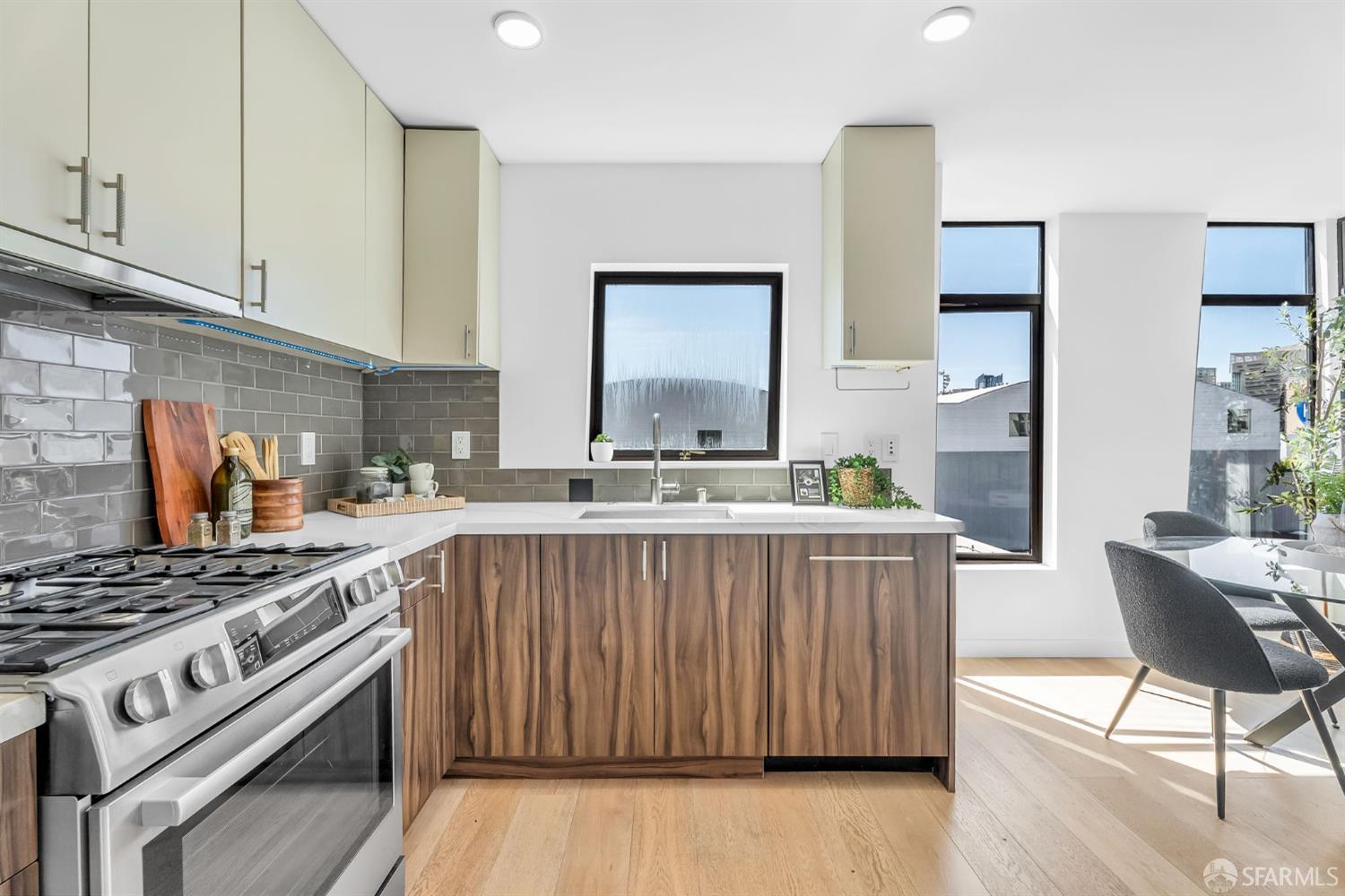 236 Shipley, Unit 405 San Francisco, CA 94107 - Photo 7 of 35 a kitchen with stainless steel appliances granite countertop a stove a sink dishwasher and cabinets with wooden floor