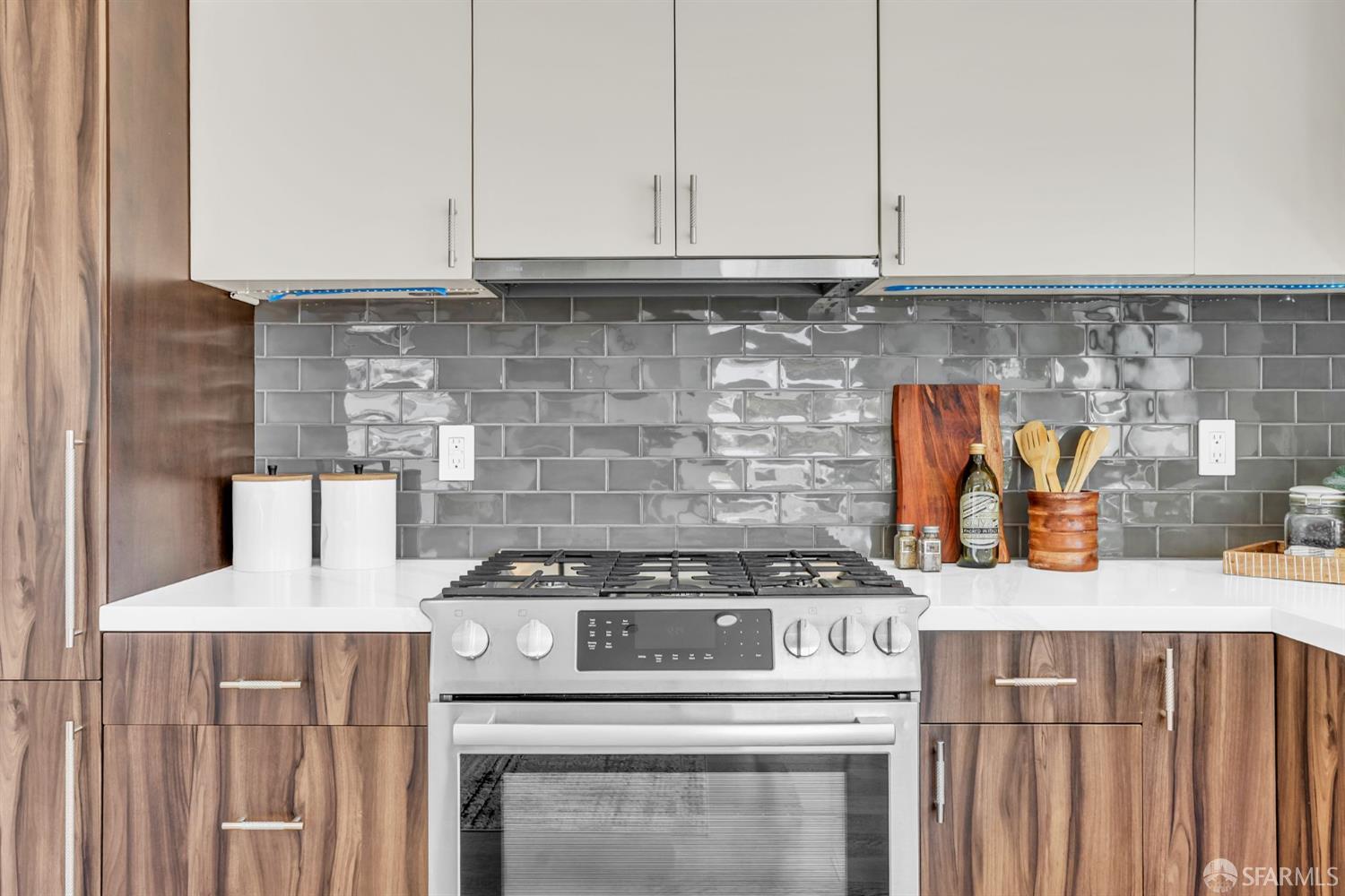 236 Shipley, Unit 405 San Francisco, CA 94107 - Photo 10 of 35 a kitchen with granite countertop a stove a sink and white cabinets