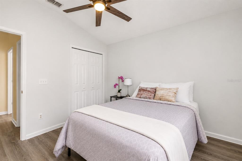 12232 Bronson Way Orlando, FL 32824 - Photo 19 of 32 a bedroom with a bed and a chandelier