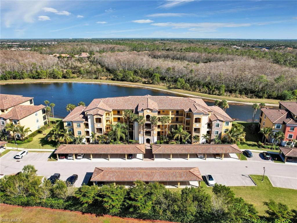 9584 Trevi Court, Unit 5213 Naples, FL 34113 - Photo 2 of 50 an aerial view of a house with a garden and lake view
