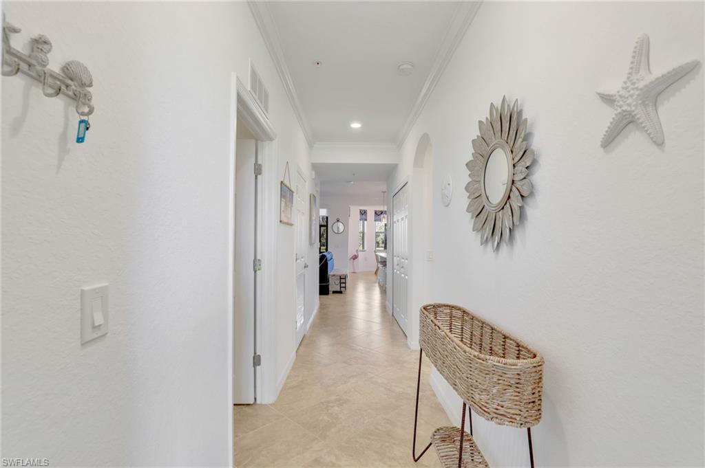 9584 Trevi Court, Unit 5213 Naples, FL 34113 - Photo 3 of 50 a view of a hallway with seating area