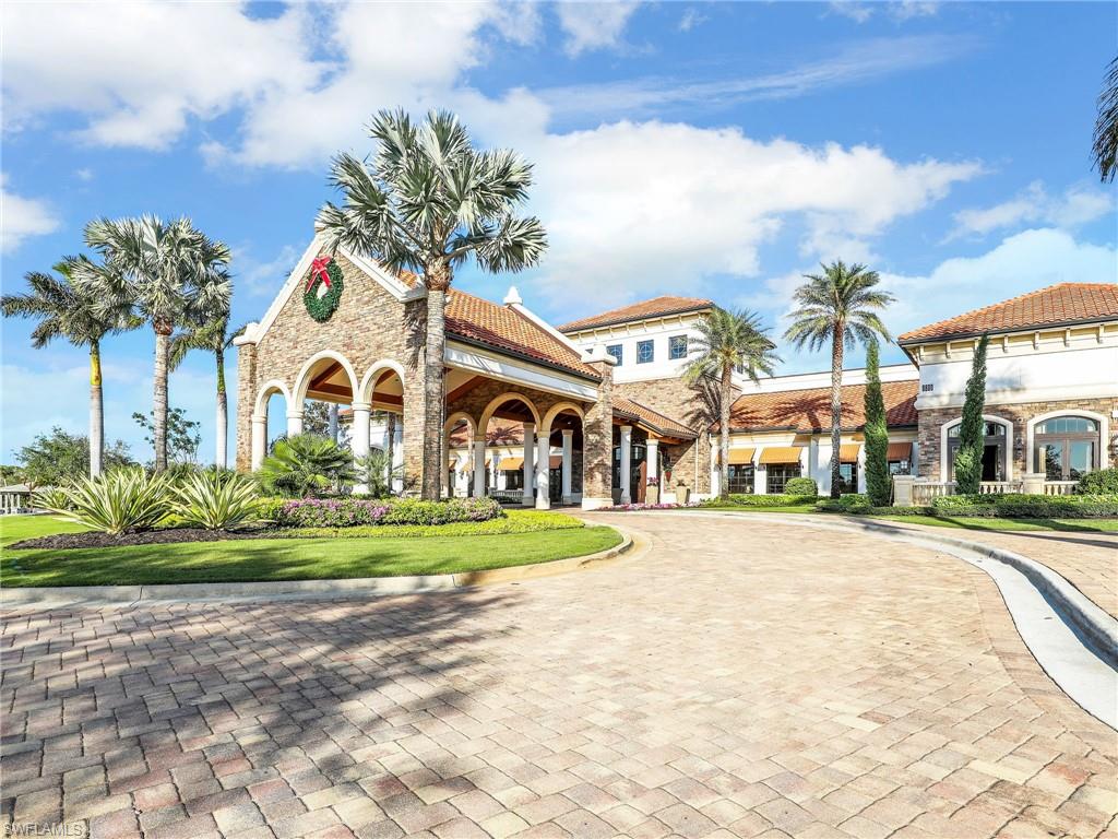 9584 Trevi Court, Unit 5213 Naples, FL 34113 - Photo 44 of 50 a front view of a house with a yard and potted plants