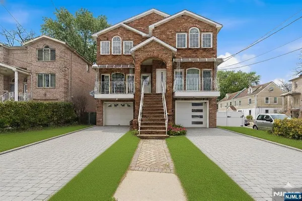 a front view of a house with a garden and yard