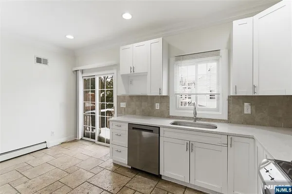 a kitchen with a sink cabinets and window