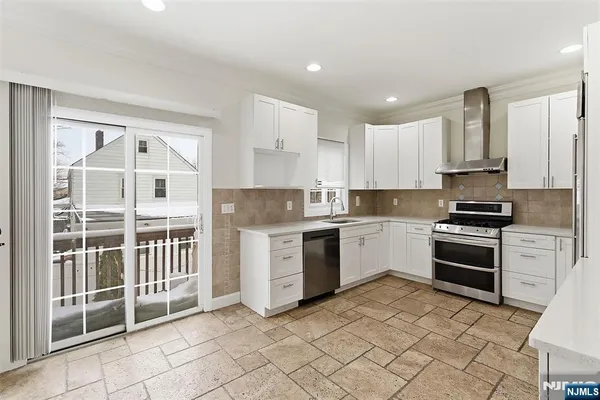 a kitchen with a stove a sink and a refrigerator