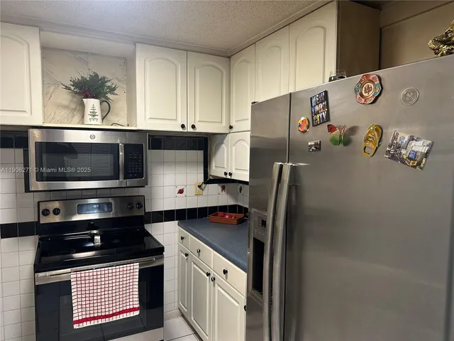 a kitchen with stainless steel appliances granite countertop a stove and a refrigerator