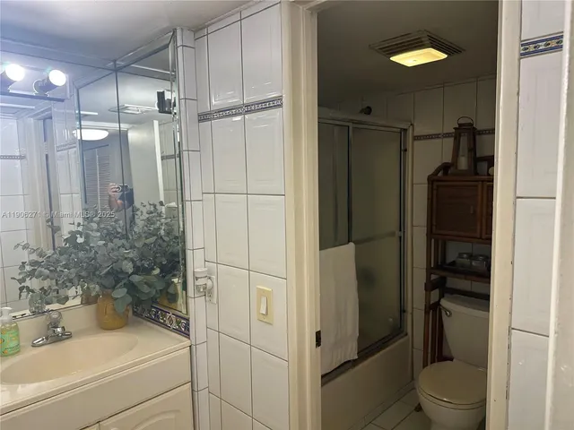 a bathroom with a sink vanity and a mirror